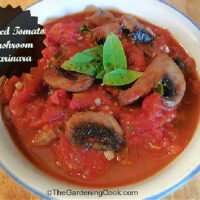 A bowl of mushroom tomato pasta sauce with mushrooms and basil. Black text box reads Roasted tomato mushroom marinara.