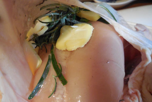 Herbs and butter under the skin