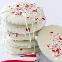 Stack of white chocolate dipped peppermint cookies.