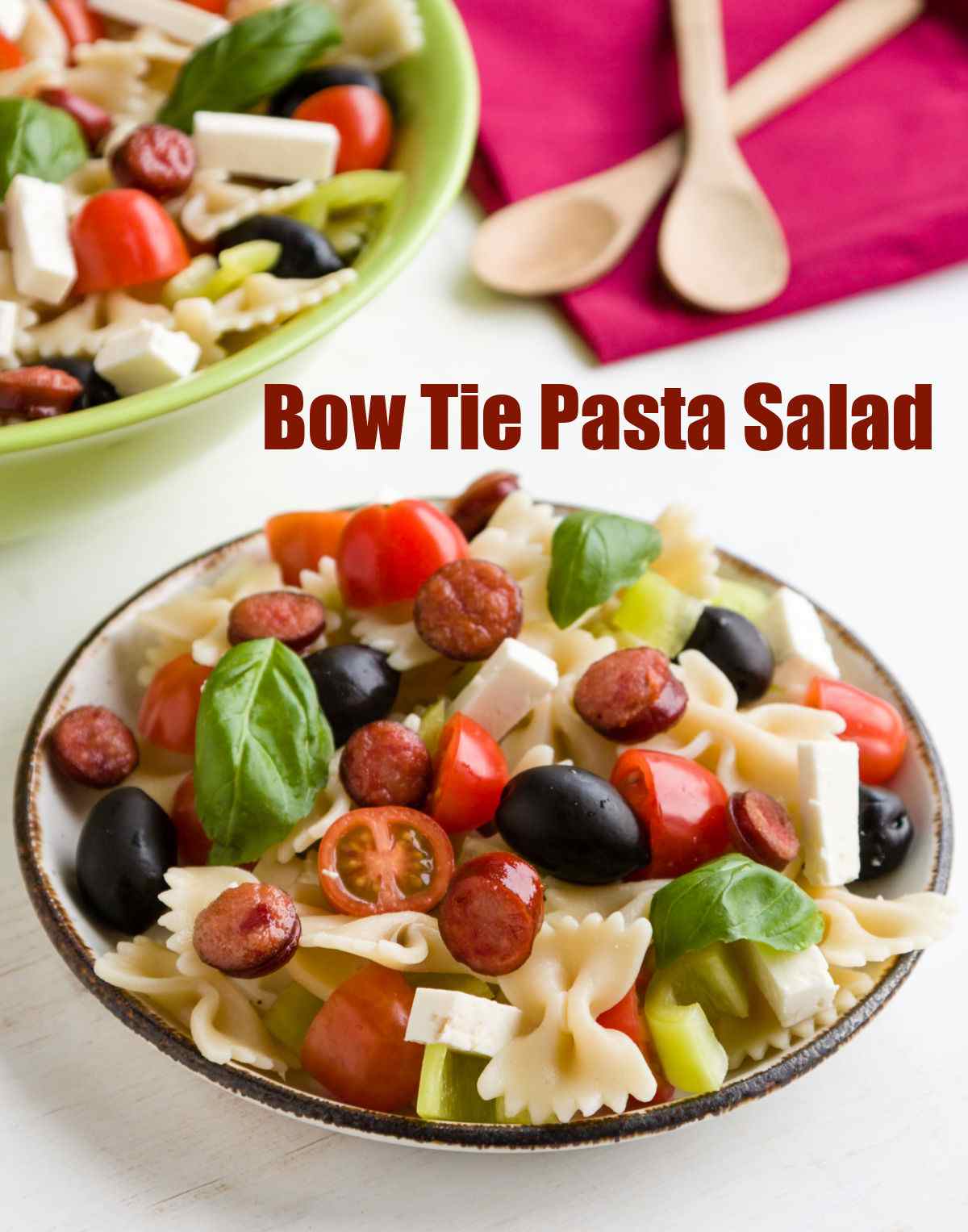 Salad with farfelle pasta, olives, basil, mozzarella and tomatoes and words Bow Tie Pasta Salad.