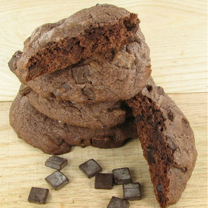 chocolate chunk cookies 3 double chocolate chunk cookies in a pill next to pieces of large chocolate chunks.