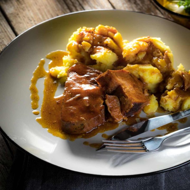 Pork roast with gravy and mashed potatoes.