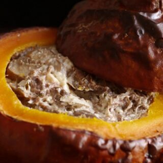 Festive pumpkin dip baked in a pumpkin bowl.