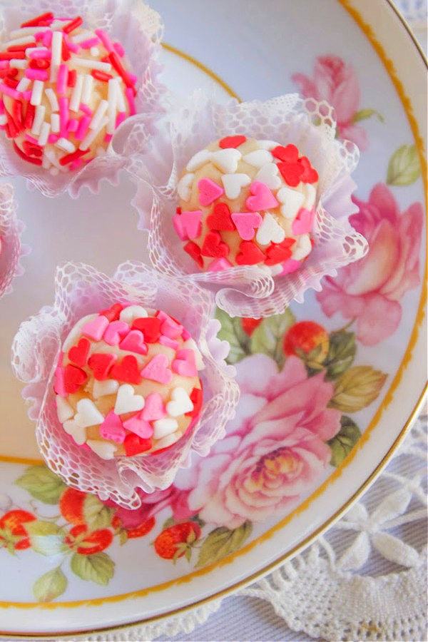 Brigadeiro white chocolate truffles on a flowered plate in mini cupcake liners.