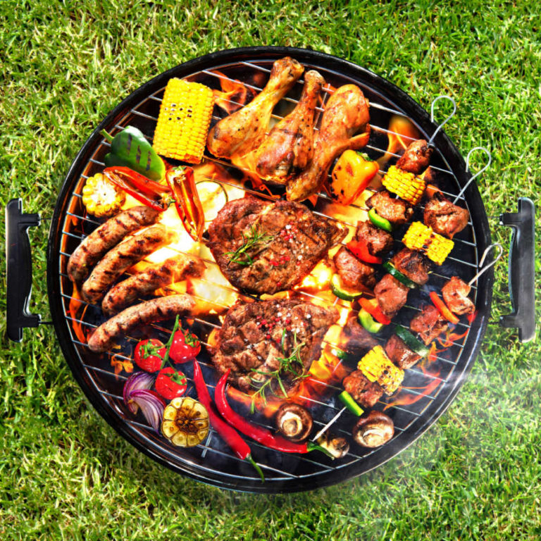 BBQ grill loaded with food for entertaining.
