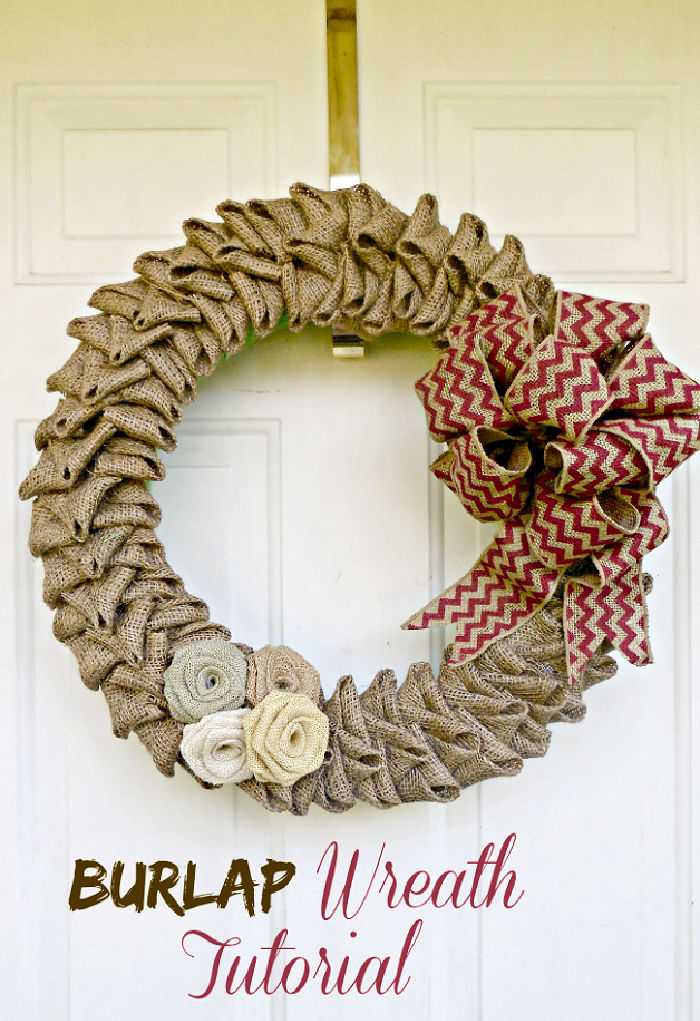 A burlap flower wreath with orange striped bow hanging on a door. Text reads Burlap wreath tutorial.