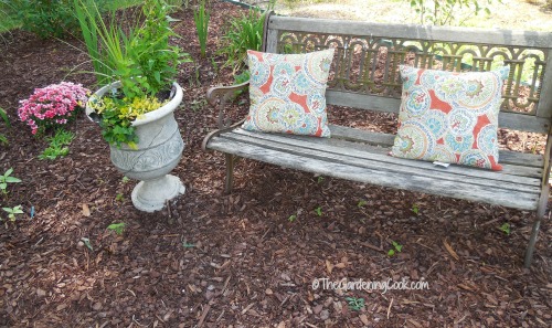 The second seating area is a park bench and overlooks the whole garden bed.