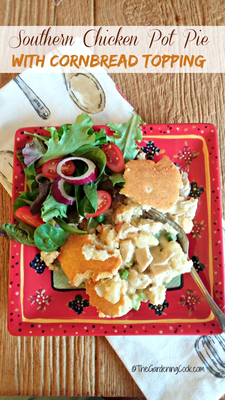 Chicken casserole on a plate with salad and text reading Southern Chicken Pot Pie with Cornbread Topping.