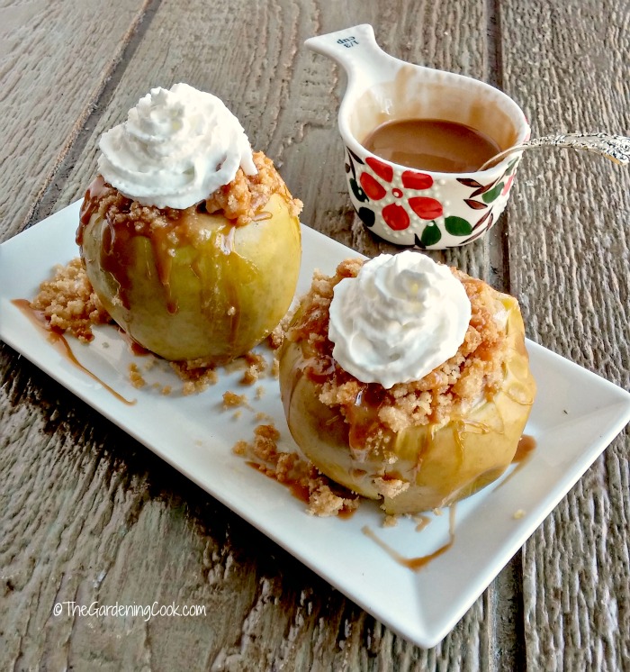Apple crumble baked apples with whipped topping and caramel topping.
