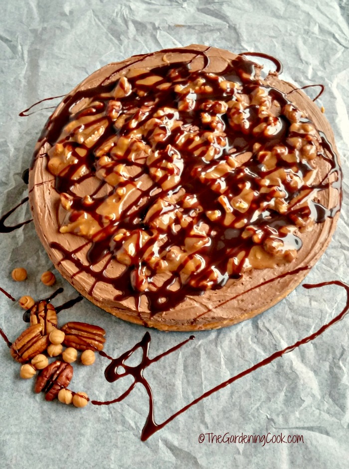 Turtle chocolate pumpkin cheesecake on parchment paper.