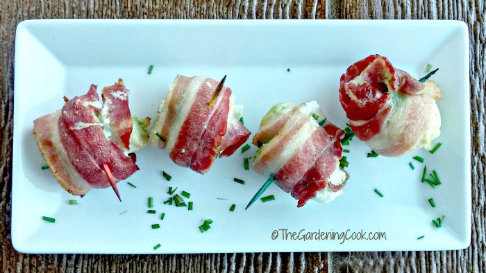Spicy bacon wrapped chicken bites on a white plate