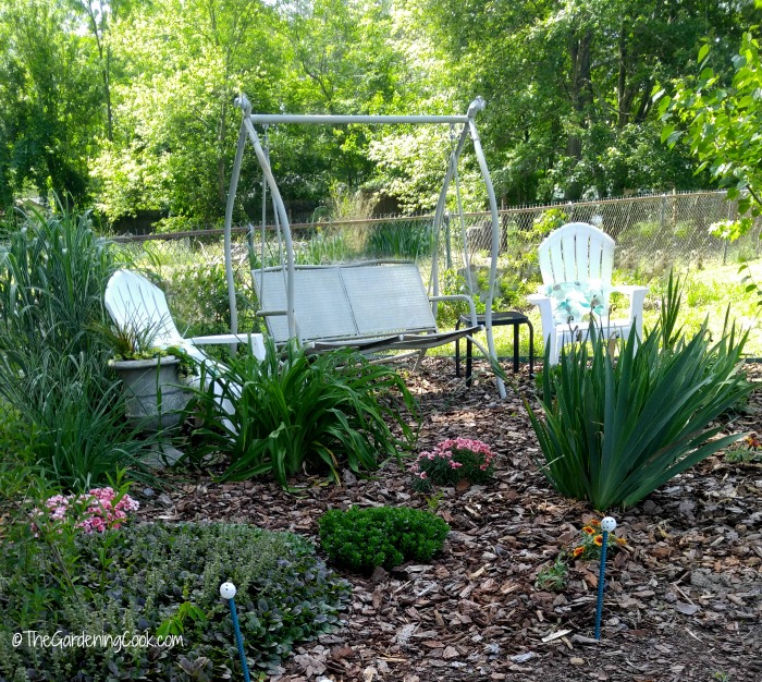 Garden swing and adirondack chairs