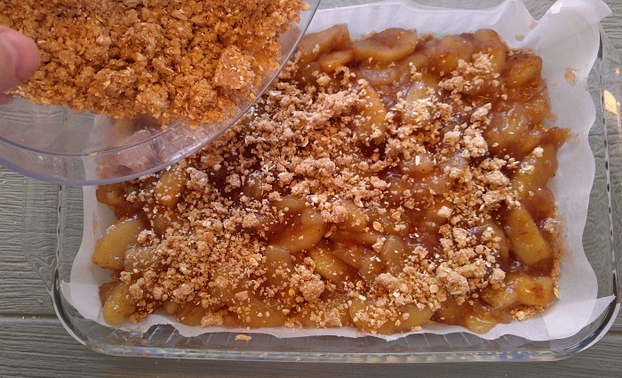 Apple pie filling in a pan with oat crumble topping.
