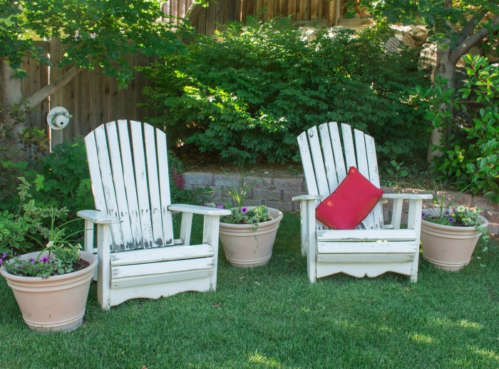 White wood garden furniture with flower pots