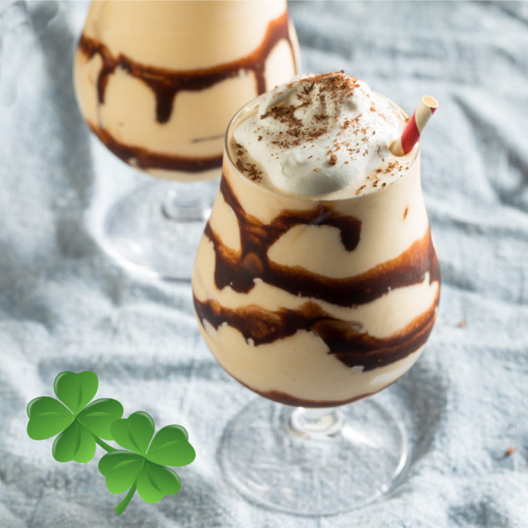 Bailey's mudslide cocktail with whip cream in a drizzed glass with two shamrocks