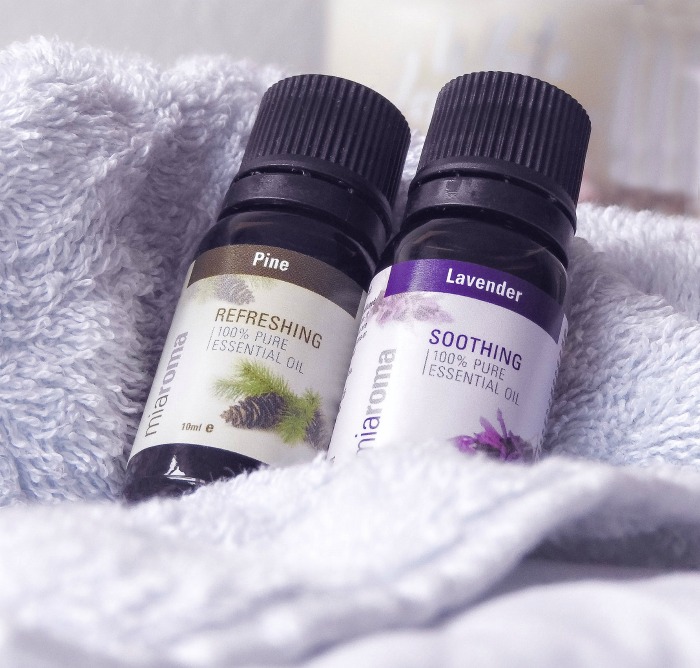 Pine oil and lavender oil on a purple towel