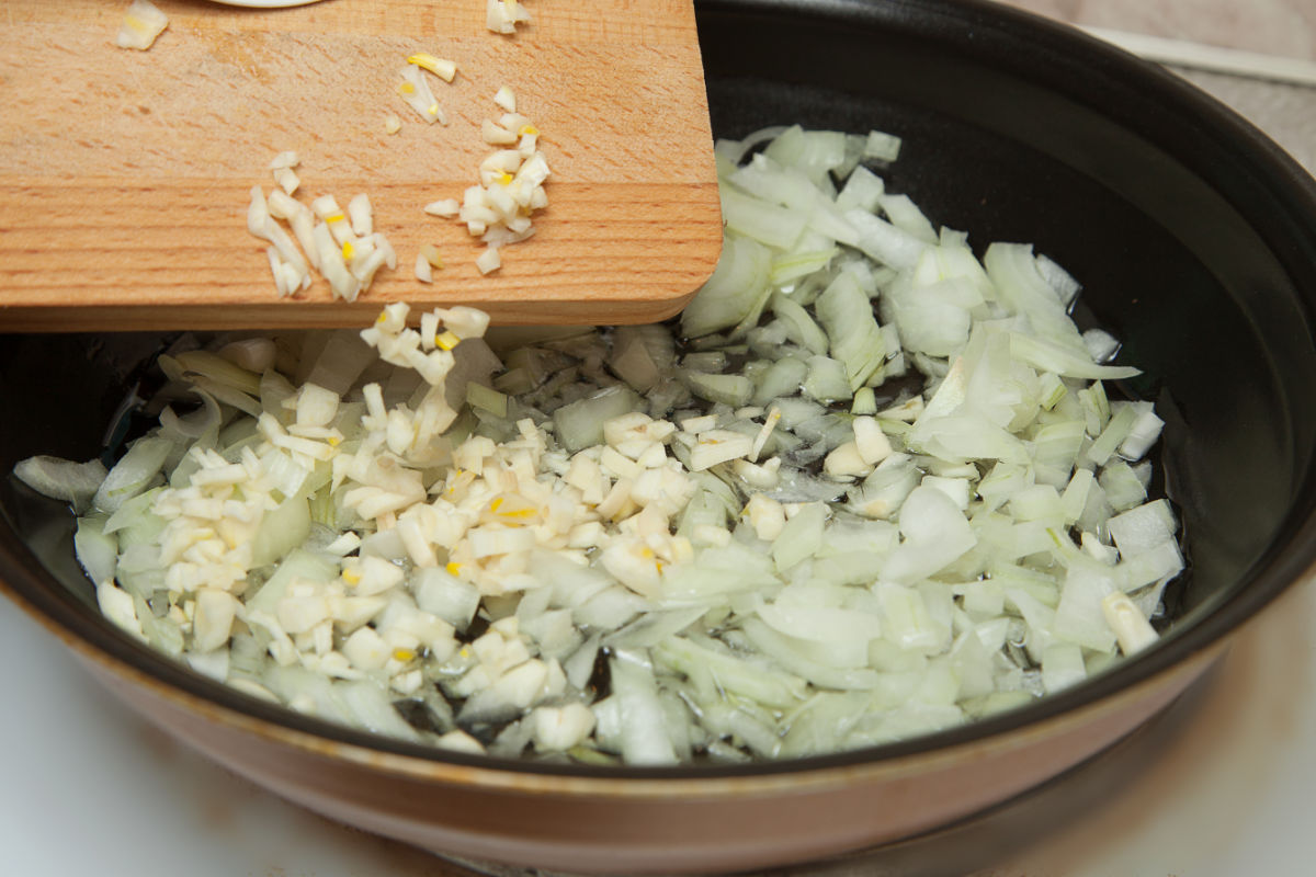 Cooking onions and garlic in a frying pan.