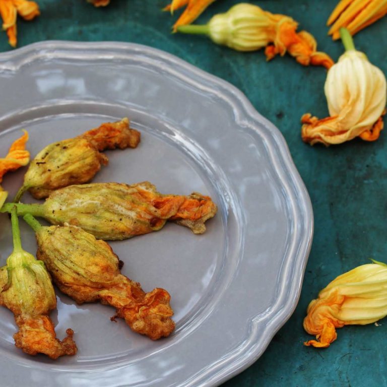 Fried squash blossoms on a gray plate.