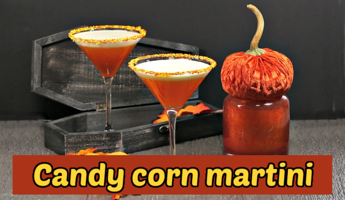 Two layered orange cocktails next to a leaf, velvet pumpkin, candle and black coffin. Yellow text reads Candy corn martini.
