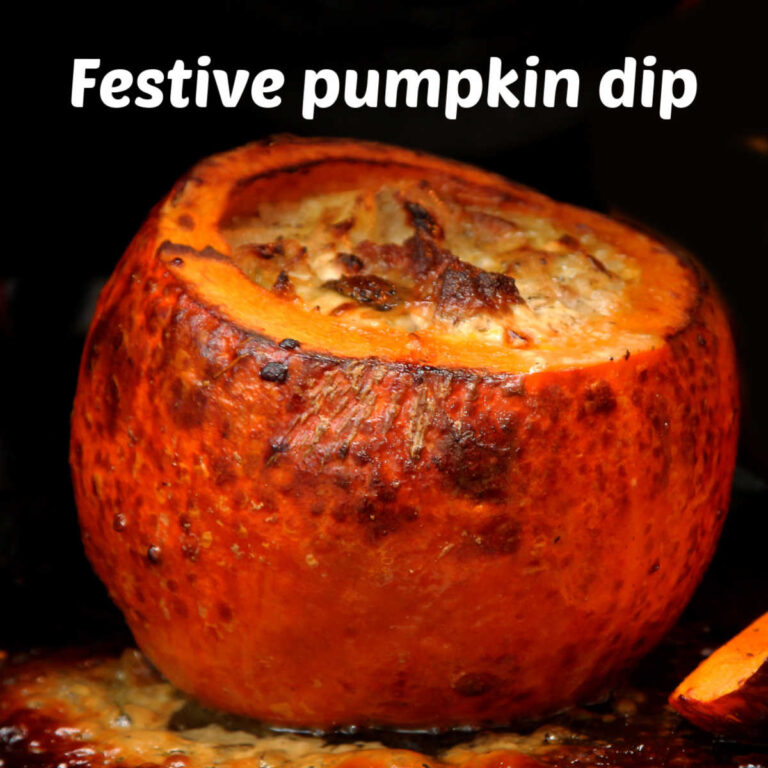 Pumpkin dip baked in a pumpkin bowl. White text reads festive pumpkin dip.