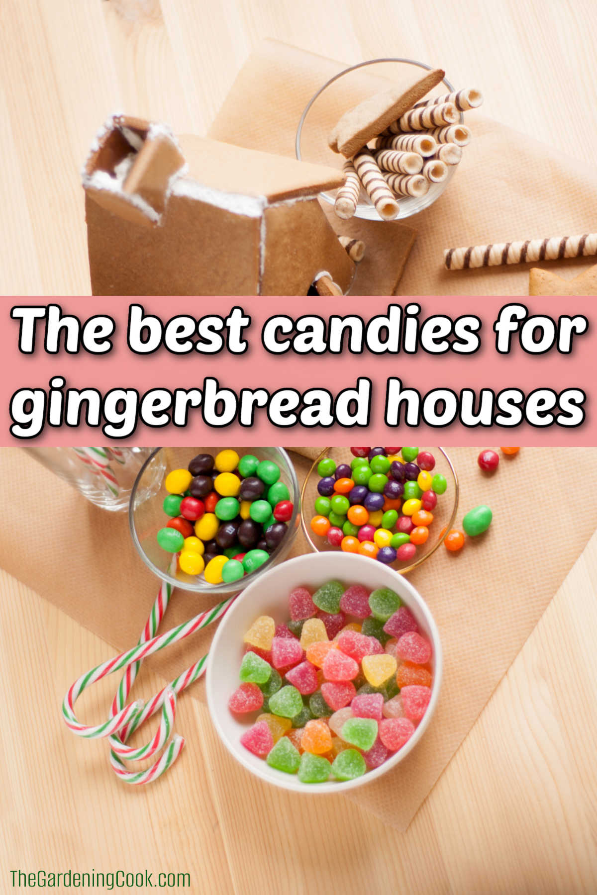 An unfinished gingerbread house on a table with bowls of candy. Pink text box reads The best candies for gingerbread houses.