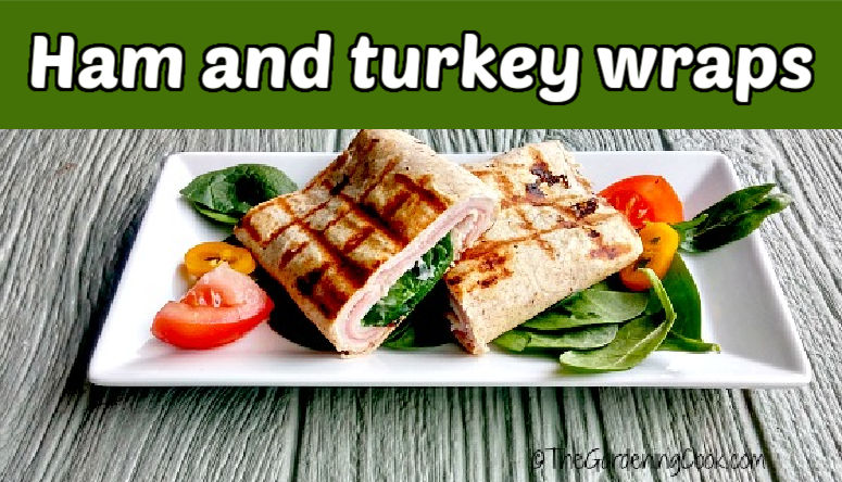 Grilled turkey cordon bleu wraps on a white plate with a salad. Green text reads ham and turkey wraps.