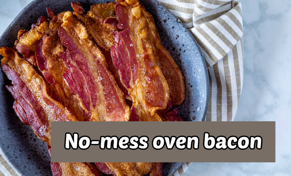 Oven bacon recipe in a blue bowl next to a striped towel. Tan text reads no mess oven bacon.