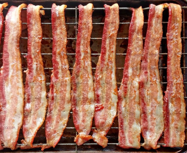 Bacon that has been cooked in the oven on a baking rack.