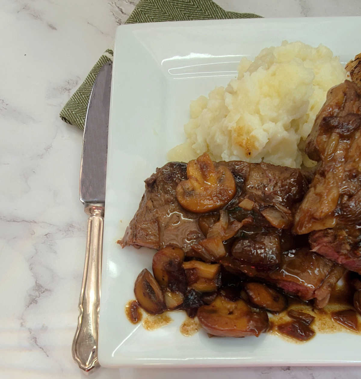 Gaelic steak topped with rich Baileys sauce for steak, served with mashed potatoes and garlic bread.