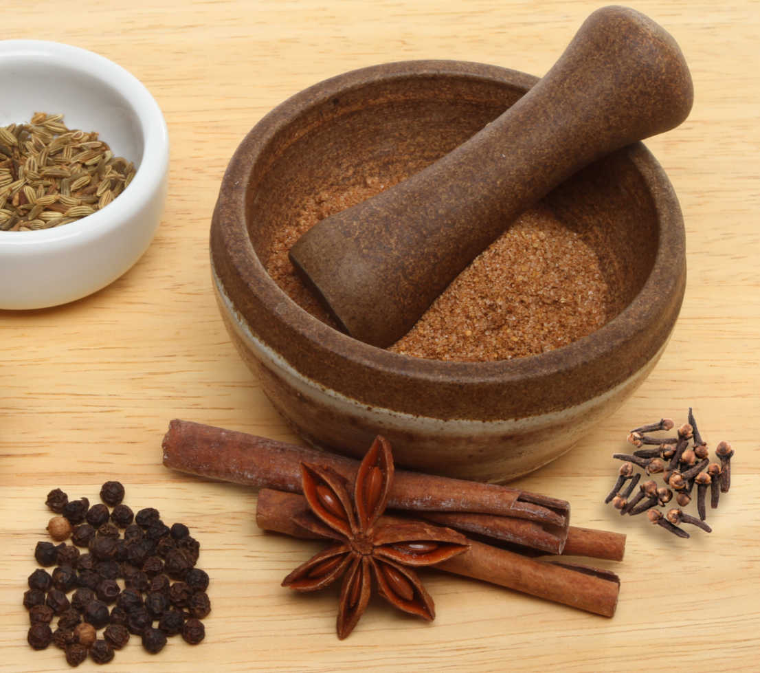 Star anise, cinnamon, cloves, fennel seeds and peppercorns being ground into 5 spice powder.