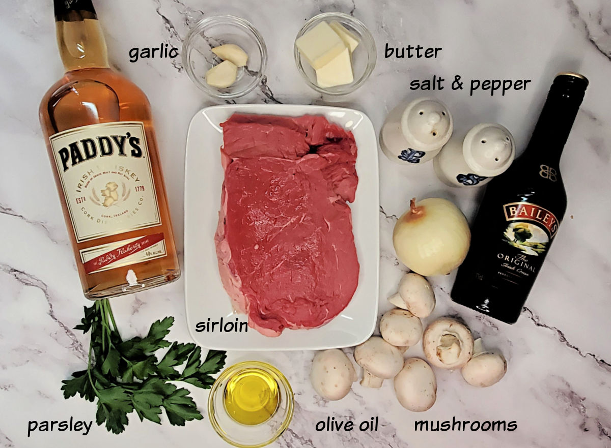 Ingredients for Irish steak sauce recipe including sirloin, Irish whiskey, Baileys, mushrooms, onion, garlic and butter.