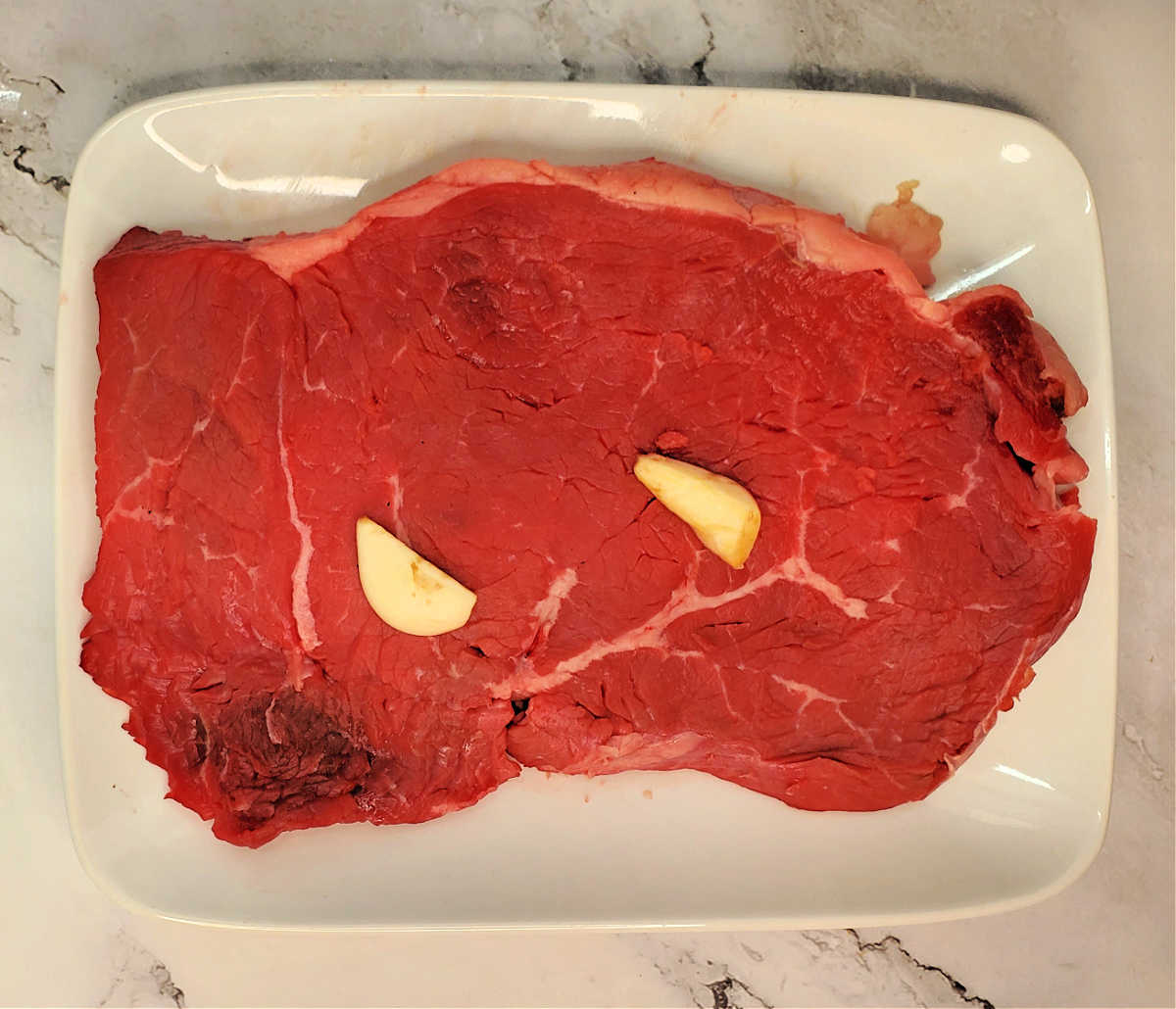 A large garlic clove, cut in half, rubbed into the outsides of a large piece of sirloin steak.